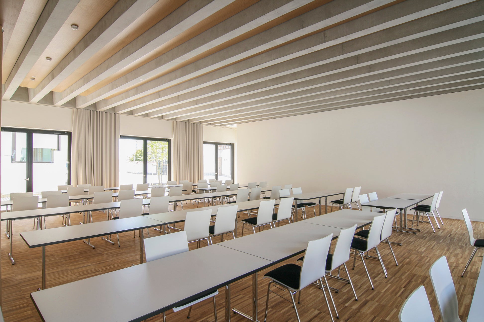 Innenraum mit flexibler Raumgliederung und warmen Holzelementen in der neuen Ortsmitte Wettstetten.